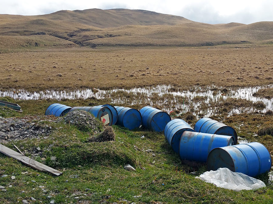 barrels scattered by creek