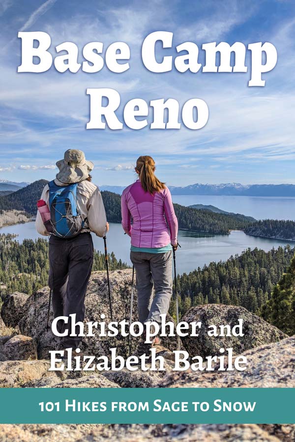 A book cover features two people standing on a rocky outlook over Lake Tahoe's Emerald Bay in hiking gear. The title reads, "Base Camp Reno: 101 Hikes from Sage to Snow"