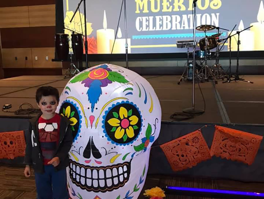 child poses at day of the dead celebration