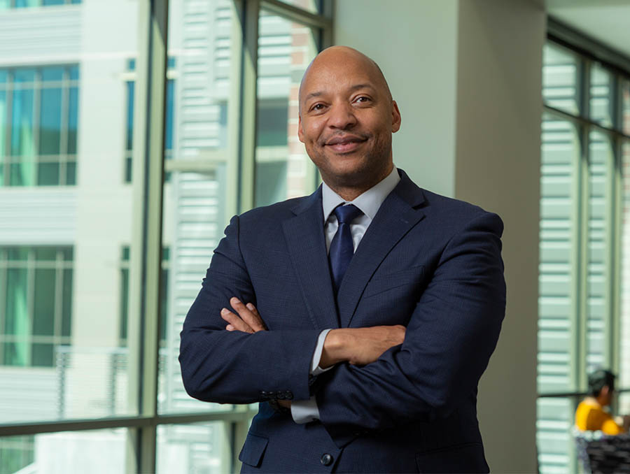 Erick Jones standing inside a building, windows in the background.