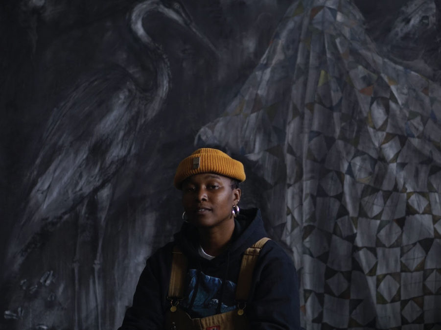 Portrait photography of Sydney Cain against a black fabric backdrop