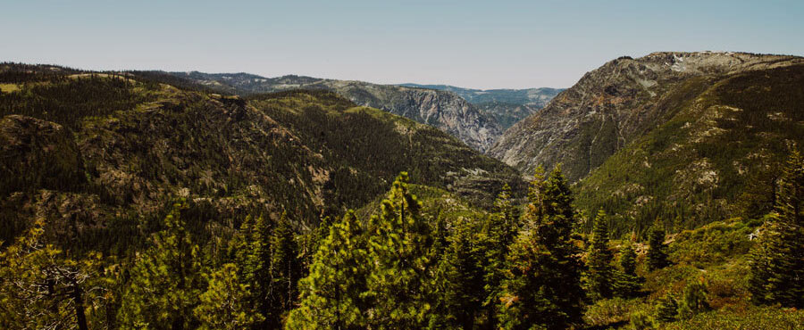 A mountainous landscape shows where a river carved in a panoramic view of the canyon.