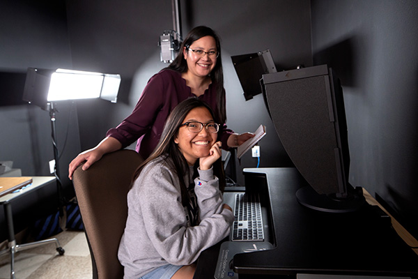 Katherine Dirk and Kayla Arcangel seen working in Libraries Digitization Lab. 