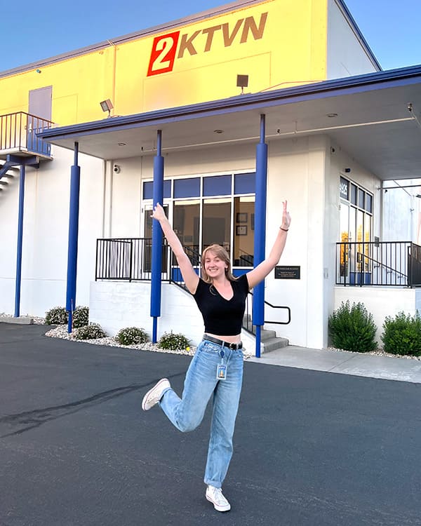 Chloe Cross stands in front of the KTVN2 News building.