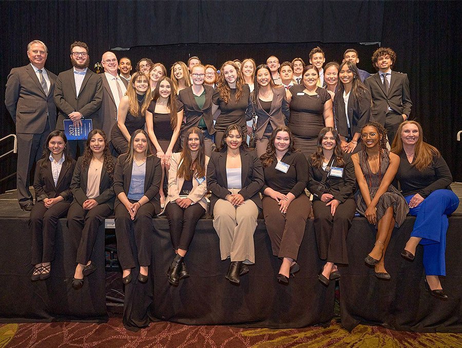 Business Student Council members dressed in business professional attire with faculty advisors Jen Nelson and Jim McClenahan