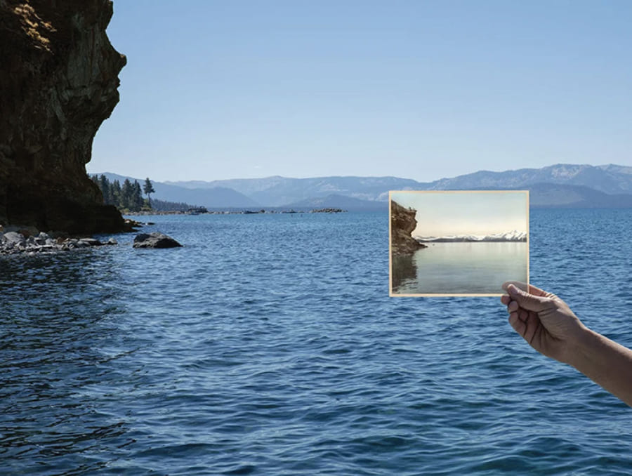 Person holding up a picture of Cave Rock at Cave Rock at Lake Tahoe.