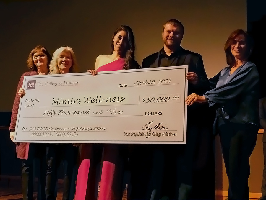 Five people holding a giant check awarding $50,000 to Mimirs Well-Ness with a memo for Sontag Entrepreneurship Competition