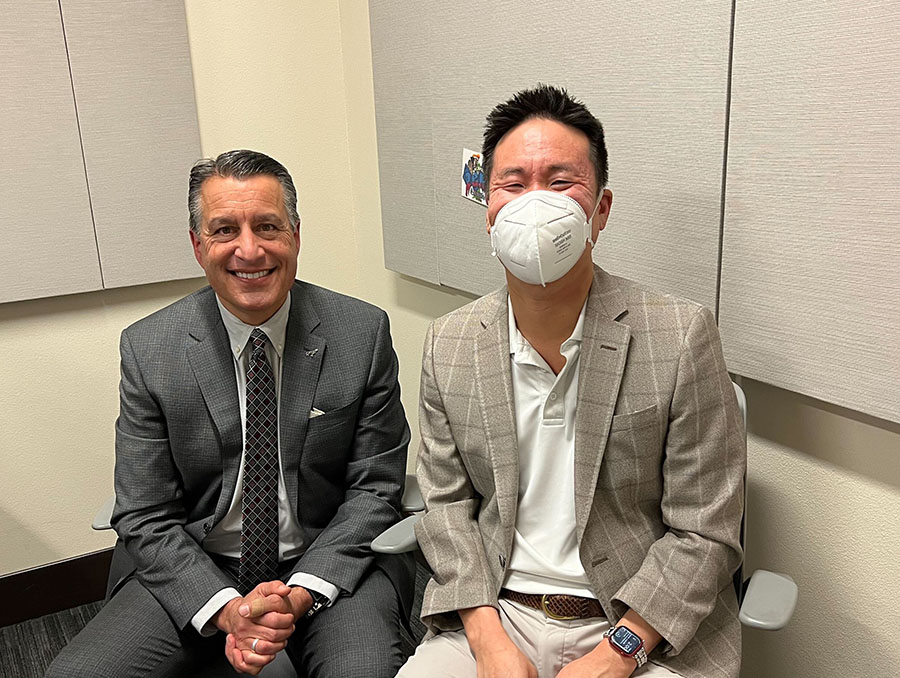 President Sandoval sits to the left of Matt Means in a podcast recording room.