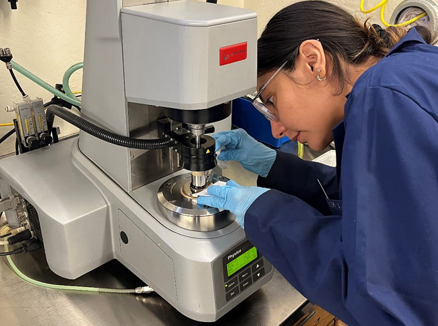 student tests plastic pavement in machine