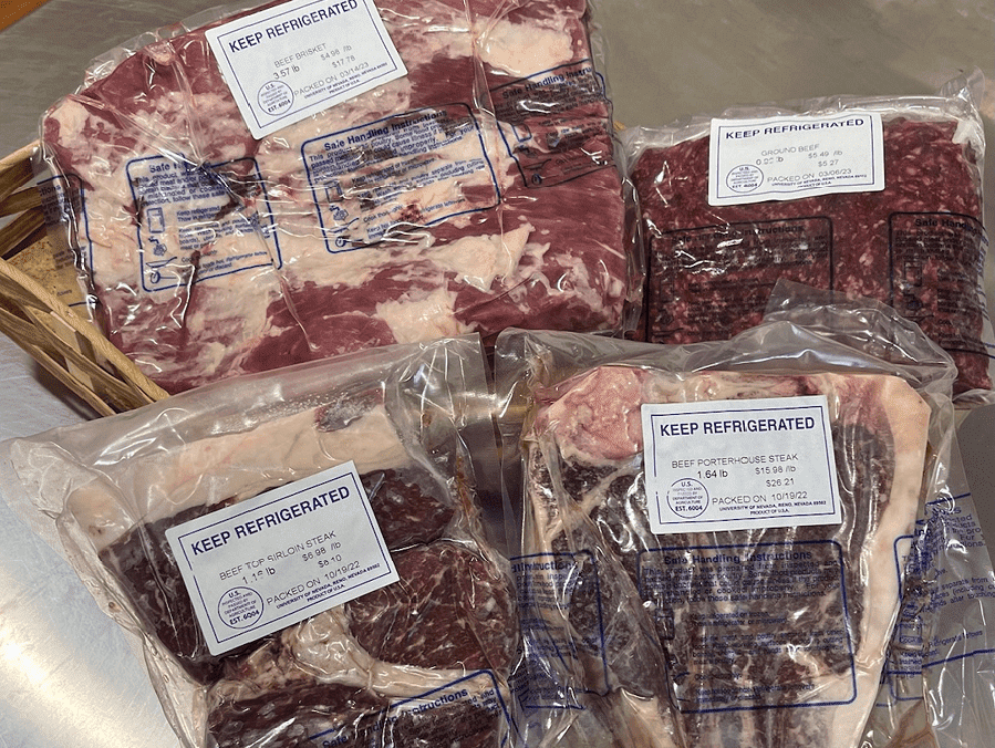 Examples of Wolf Pack Meats packaged up and laying on a table.