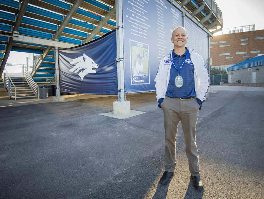 UNR Med Sports Medicine Fellowship Assistant Director Mark Stovak in front of Mackay Stadium