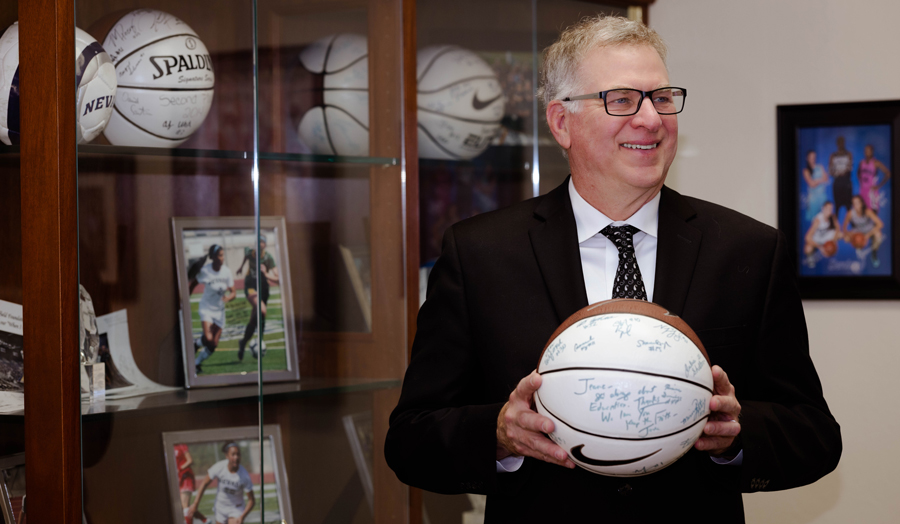 Ken Coll holds a basketball