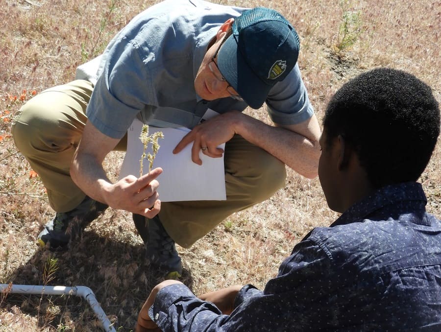 Eusden teaches a student how to do vegetation survey.