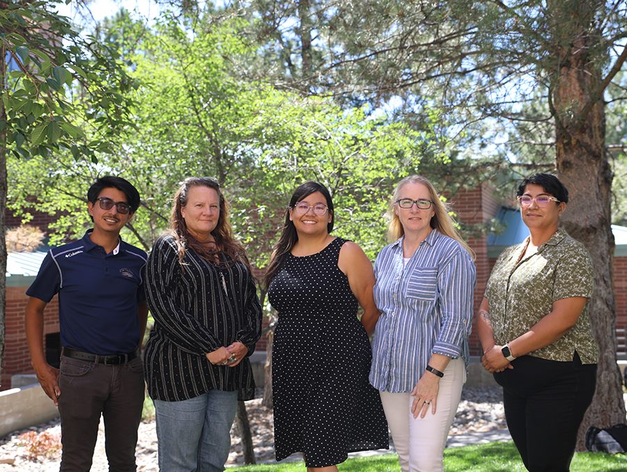 Student Success Center Staff - five people pose outside smiling.