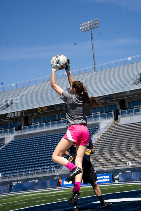 Jessica jumping in the air to save a ball from going in the goal