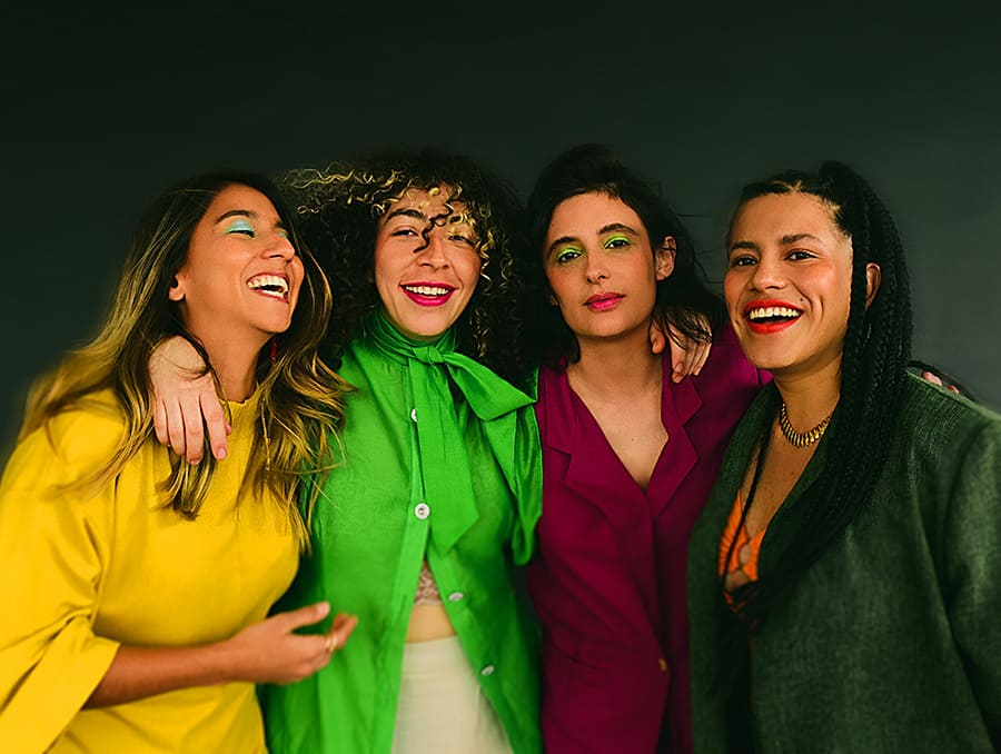 LADAMA, the Latin Alternative musicians, standing together.