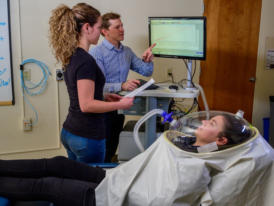 David St Jules working with a student on measuring a person's nutritional status.