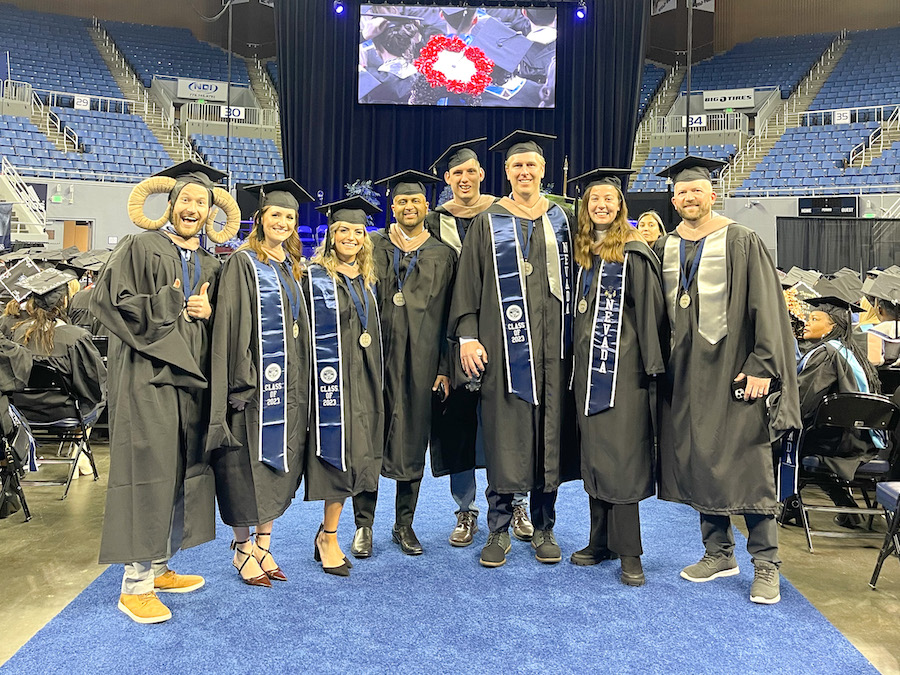 7 MBA students in the center isle of Lawlor for Commencement.