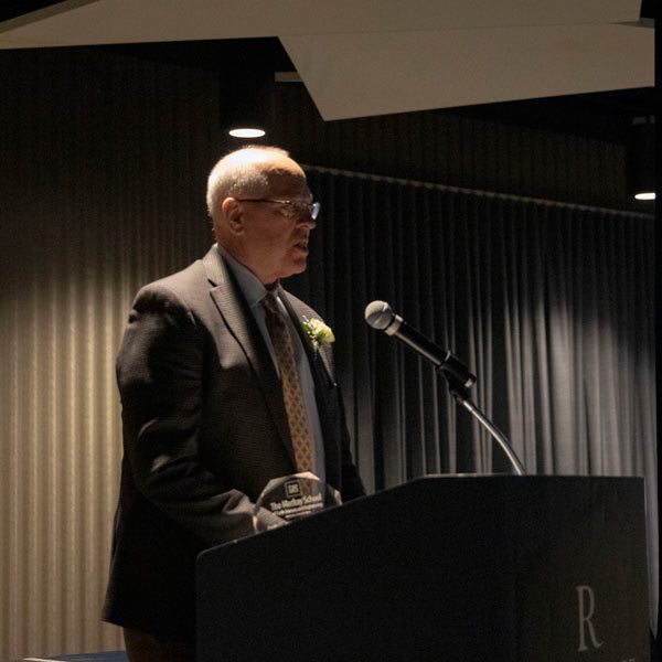 Peter Lenz speaks at a podium.