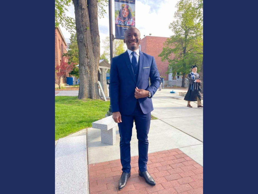 Dr. Asumah in a suit on campus at the University of Nevada, Reno.