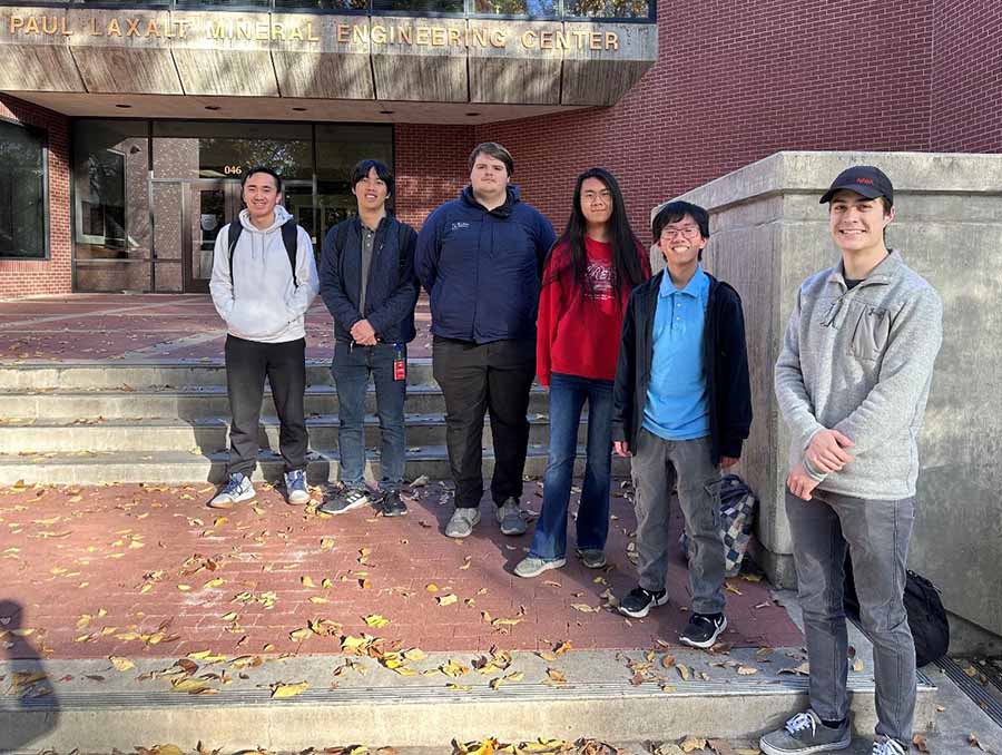 Six students stand in front of the Paul Laxalt Mineral Engineering Center building.