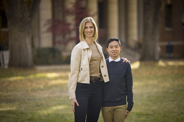 Jennifer Pearson and Dai-Nien Tran stand outside, smiling.