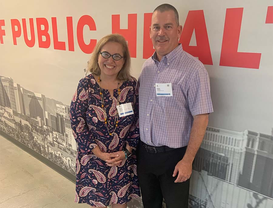 Dean Muge Akpinar-Elci and Dean Shawn Gerstenberger standing together in a hallway.