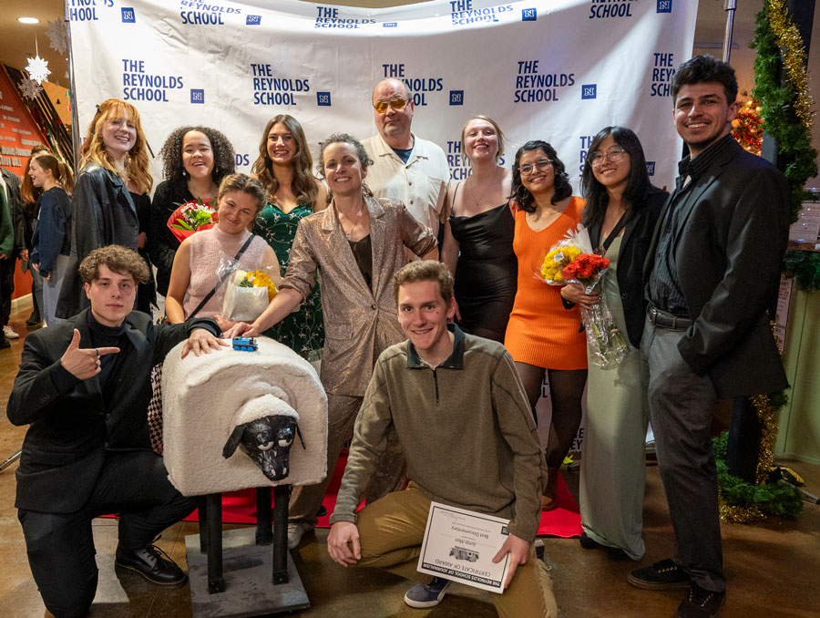 A group of students from the documentary filmmaking class and instructor Kari Barber on the red carpet.