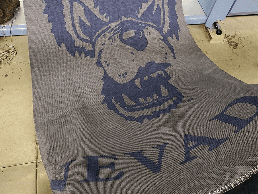 Rafter 7 Merino sheep wool made into a Nevada blanket featuring the Wolf character and "Nevada.".