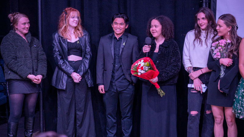 A group of students on stage responding to audience questions about their films.