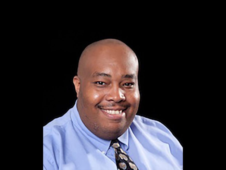 James Cox's headshot on a black background.