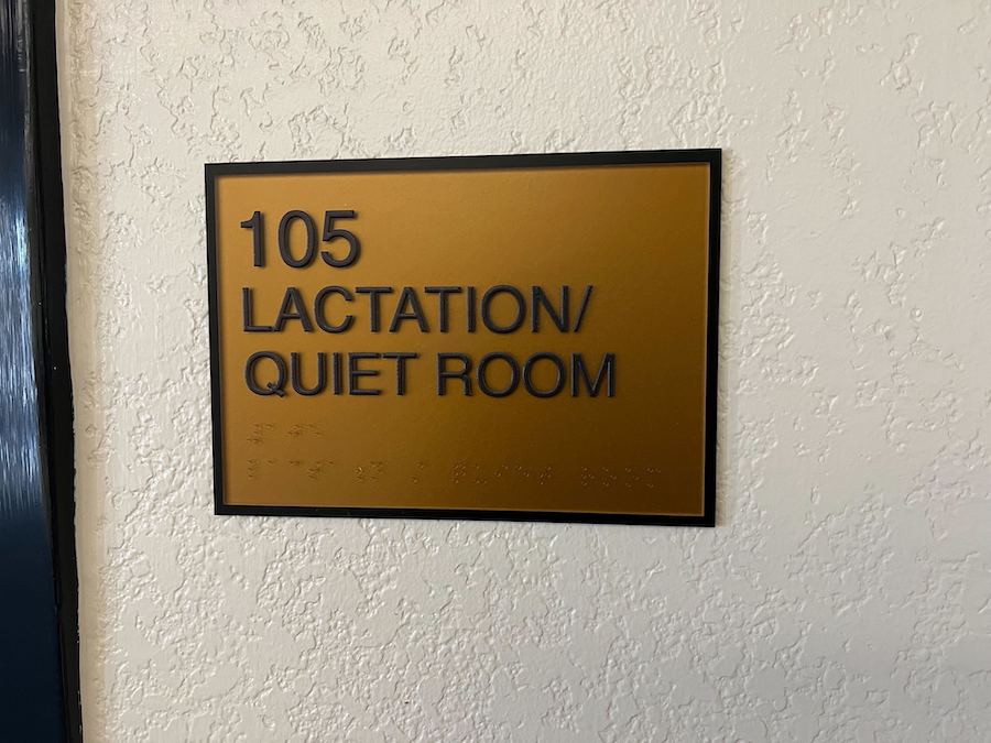 Sign outside the lactation room in the Continuing Education Building. The words "105 Lactation/Quiet Room" are written with braille underneath.