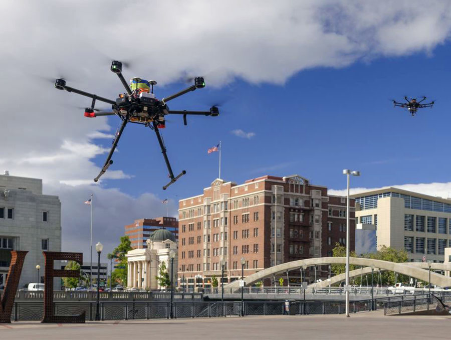Two autonomous drones flying over downtown Reno.
