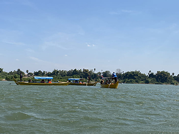 tour boats take group up Mekong River