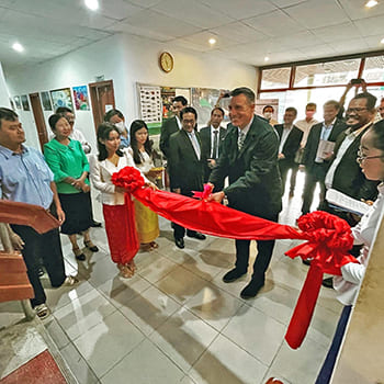 Sandoval cutting ribbon for lab grand opening