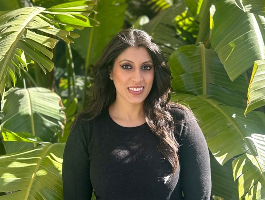 Sabina Malik with green plants in the background.