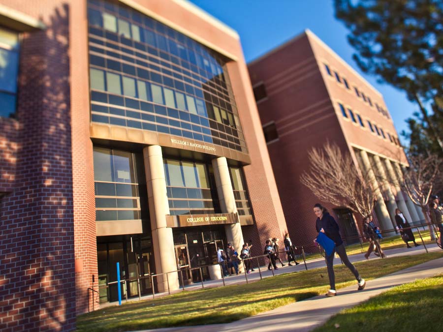 William J. Raggio building with students walking in front of the building