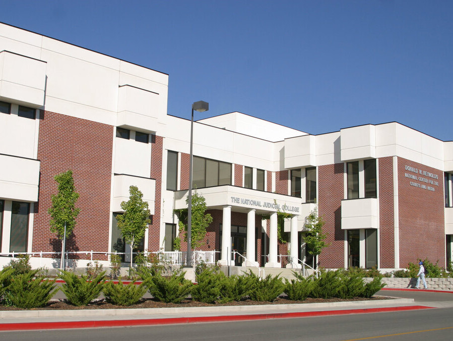 Exterior of the National Judicial College on campus at UNR on a sunny, blue sky day.