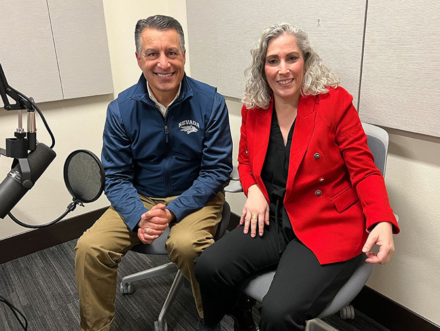 President Sandoval sits to the left of Alyssa Nota in a podcast recording room.