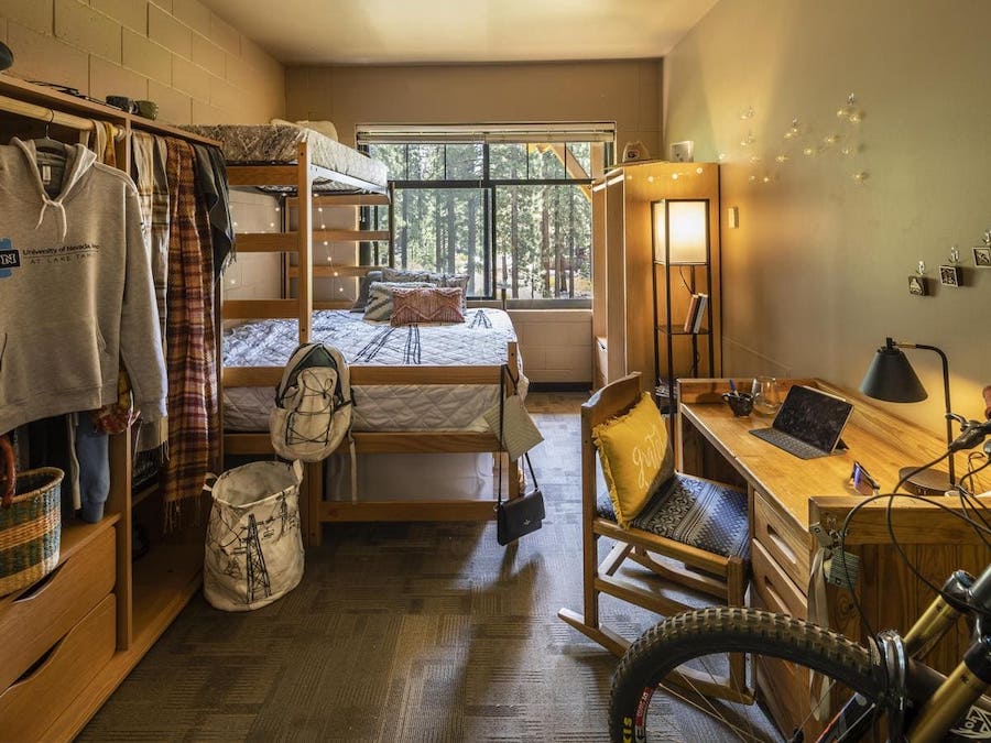 Interior of a dorm room at Lake Tahoe with a few decorations and a mountain bike.
