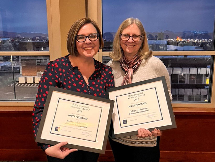 Jodee Prudente holding two awards with her mentor and professor MaryAnn Demchak, Ph.D.