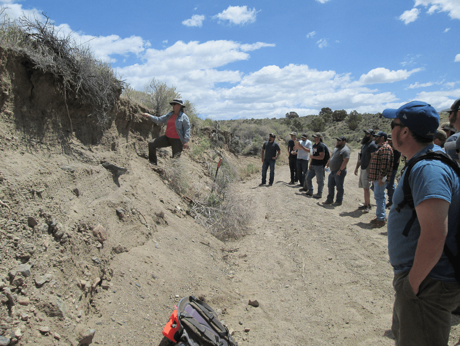Professor Tamzen Stringham outside teaching students in the Rangeland and Fire Ecology Program about the caractaristics of soil. 