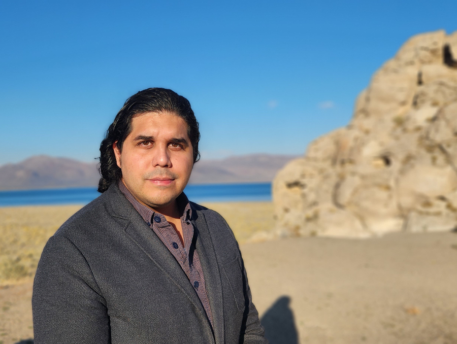 Andrew Tobey posing in front of Pyramid Lake. 