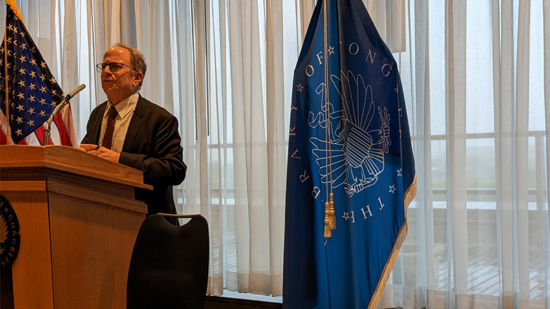 Dean Al Stavitsky speaking at a podium during his talk at the Library of Congress in Washington, D.C.