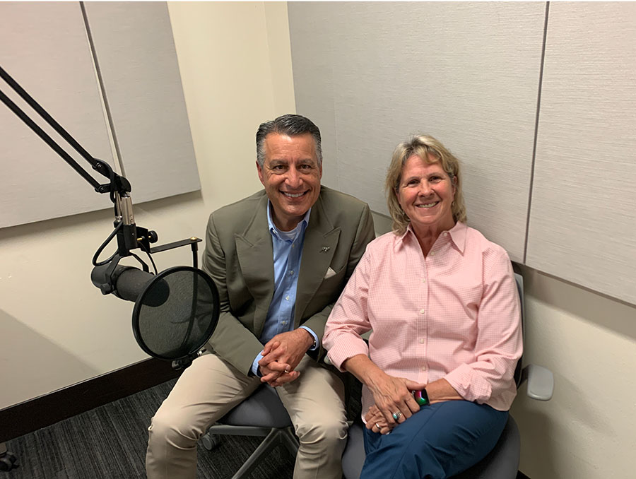 President Sandoval sits to the left of Cary Groth in a podcast recording room.