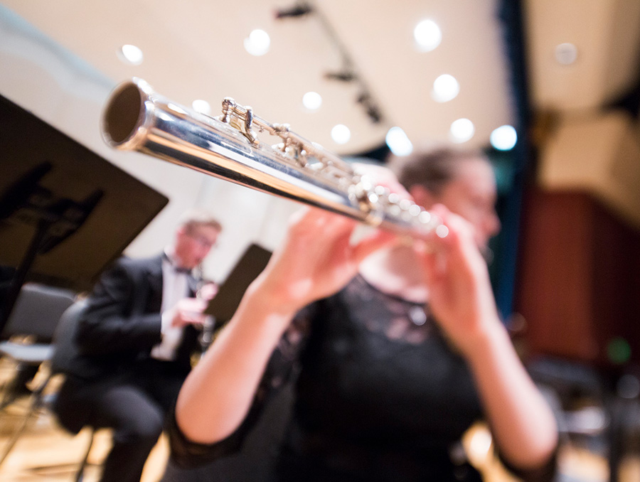 hands hold flute during recital