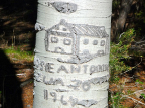 A carving of a Basque farmhouse with "Antonio Zuazo, 1964" inscribed.