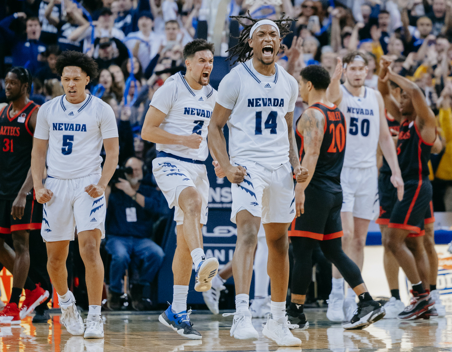 Nevada Men's Basketball players celebrate after point on home court. 