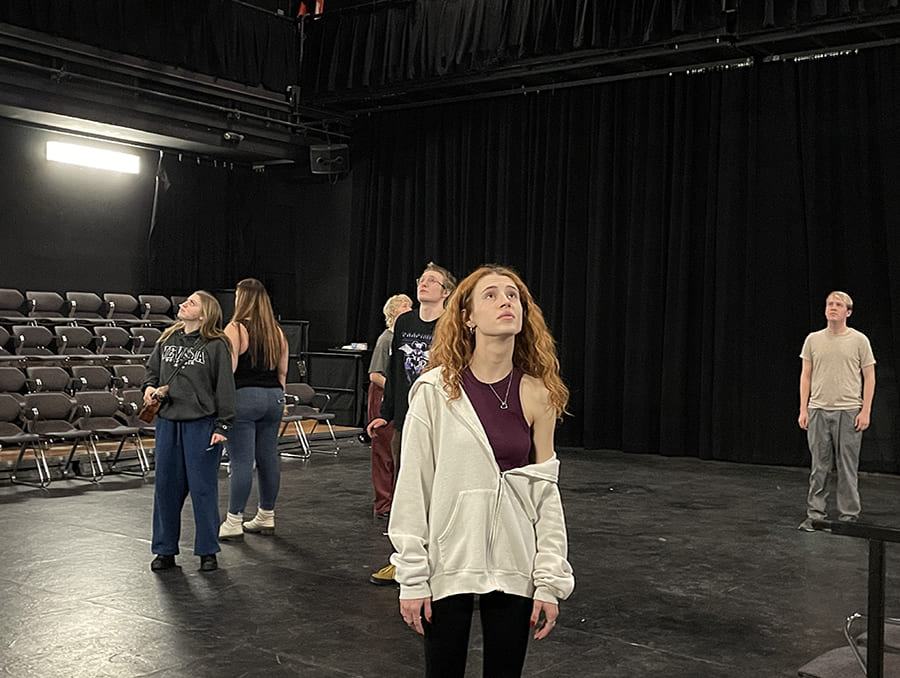 The cast of Stupid F**king Bird on stage rehearsing for their upcoming performance.