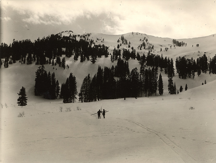 Two people stand in the snow at Mt. Rose.